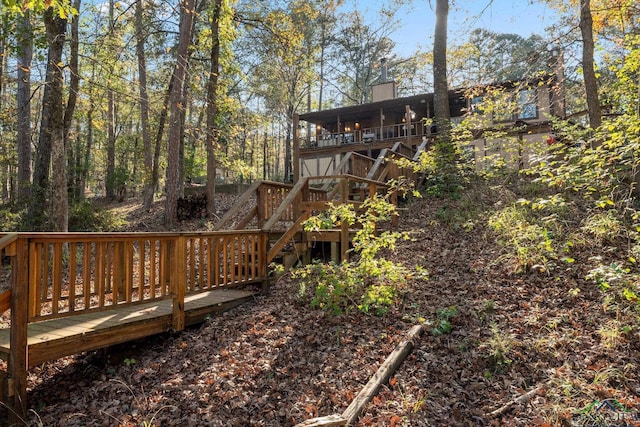 view of yard with a wooden deck and stairs