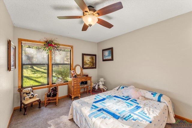 bedroom with carpet flooring, a textured ceiling, and ceiling fan