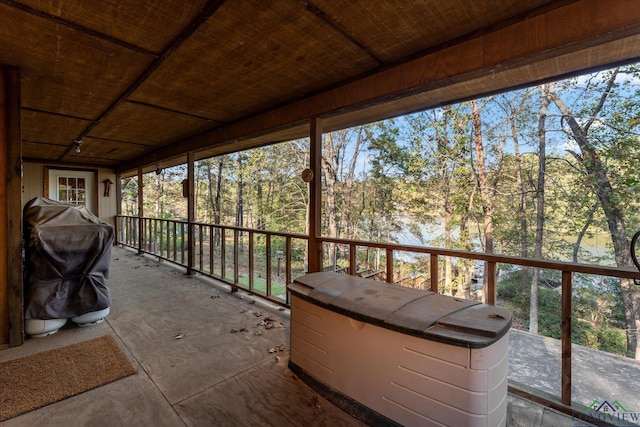 unfurnished sunroom with wood ceiling