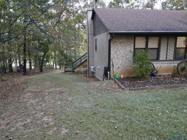 view of side of home with a lawn