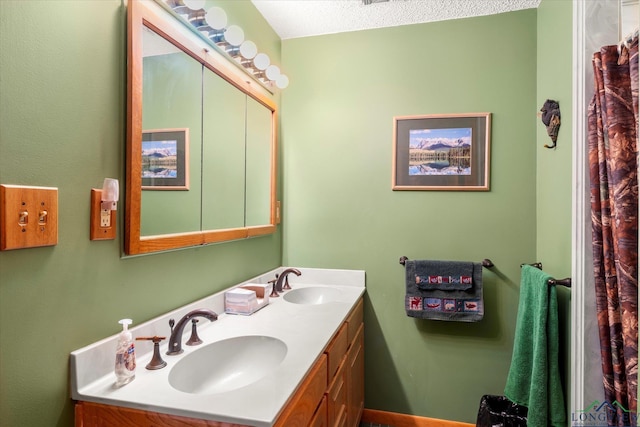 bathroom featuring vanity and a textured ceiling