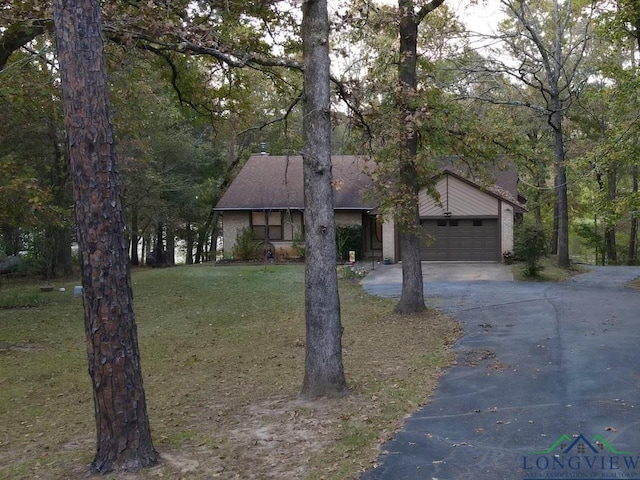 view of front of home with a garage and a front lawn