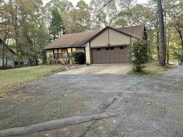 view of front of home with a front lawn and a garage