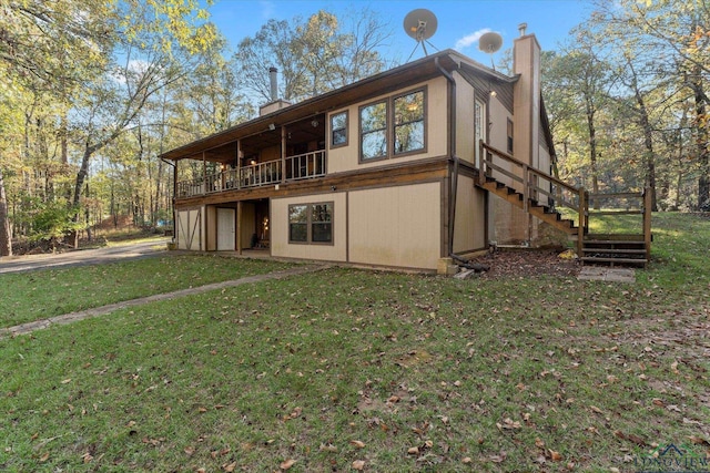 back of property featuring a yard and a deck