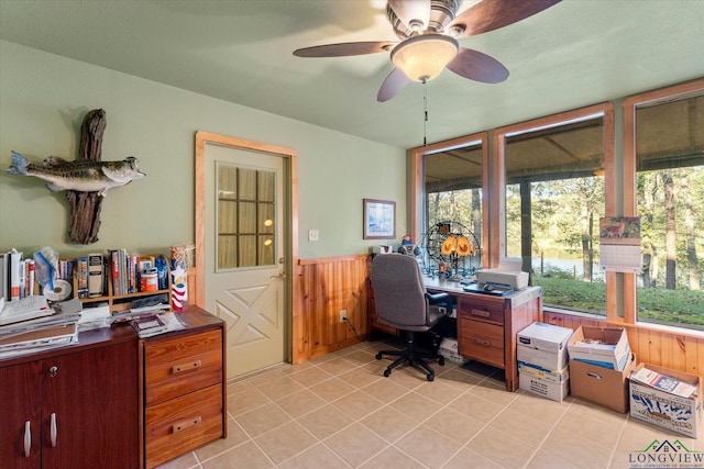 office area with ceiling fan, light tile patterned flooring, and wood walls