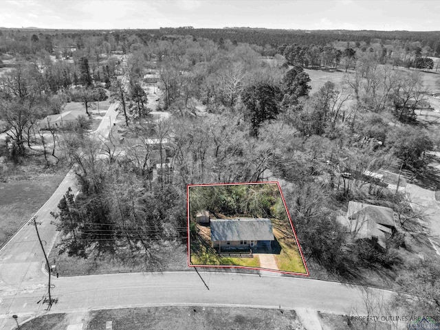 birds eye view of property featuring a forest view