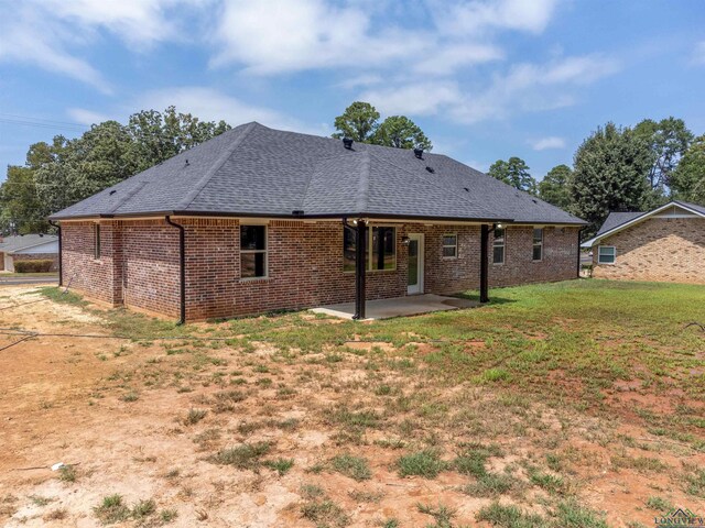 back of house featuring a yard and a patio