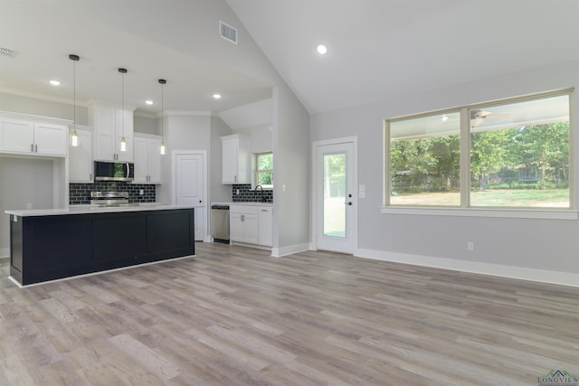 kitchen featuring pendant lighting, a center island, decorative backsplash, appliances with stainless steel finishes, and white cabinetry