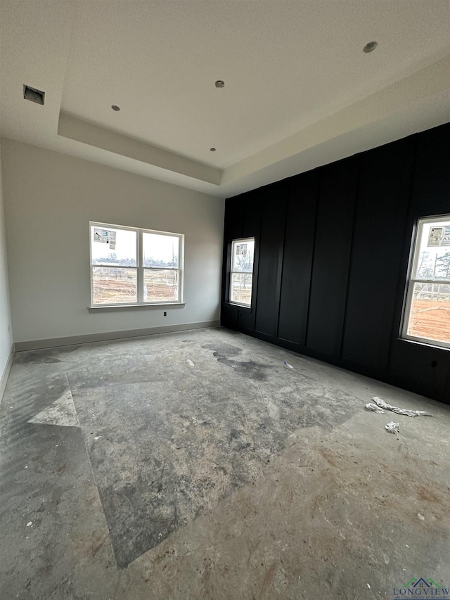 unfurnished room featuring a tray ceiling