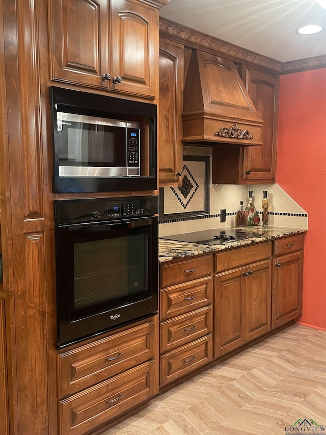 201 Mockingbird Ln, Longview, TX 75601 - kitchen with black appliances, custom exhaust hood, dark stone counters, and tasteful backsplash