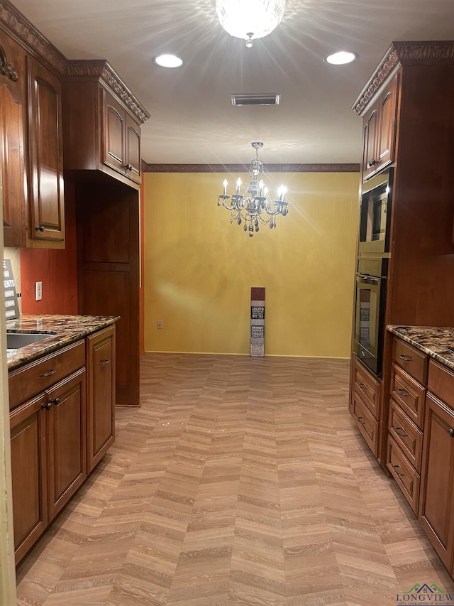 201 Mockingbird Ln, Longview, TX 75601 - kitchen with black oven, a chandelier, stainless steel microwave, dark stone counters, and hanging light fixtures