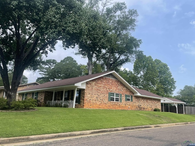 201 Mockingbird Ln, Longview, TX 75601 - ranch-style house featuring a front lawn, brick siding, and a porch