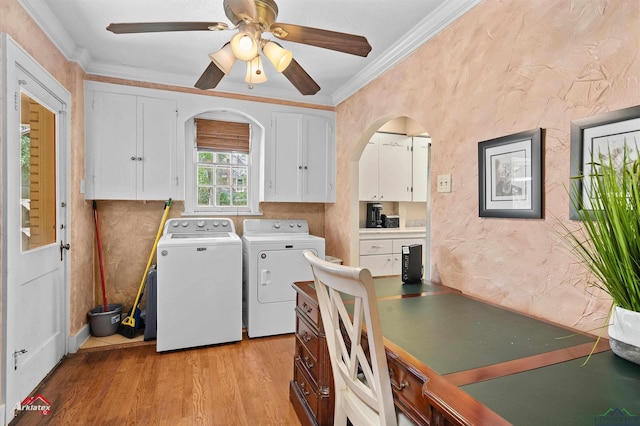 laundry room featuring ornamental molding, light wood-type flooring, separate washer and dryer, a ceiling fan, and cabinet space