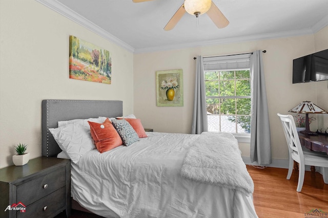 bedroom with baseboards, ceiling fan, ornamental molding, and wood finished floors