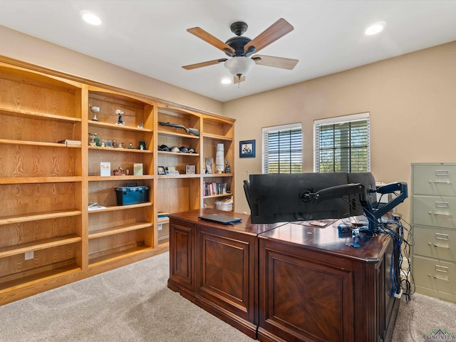 office space with light colored carpet and ceiling fan