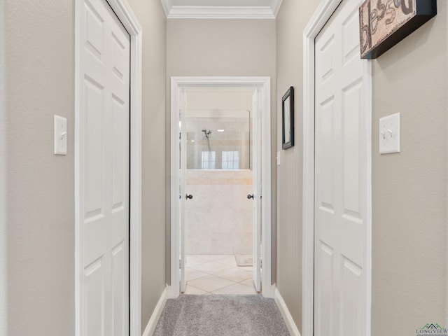 hallway with crown molding and light colored carpet