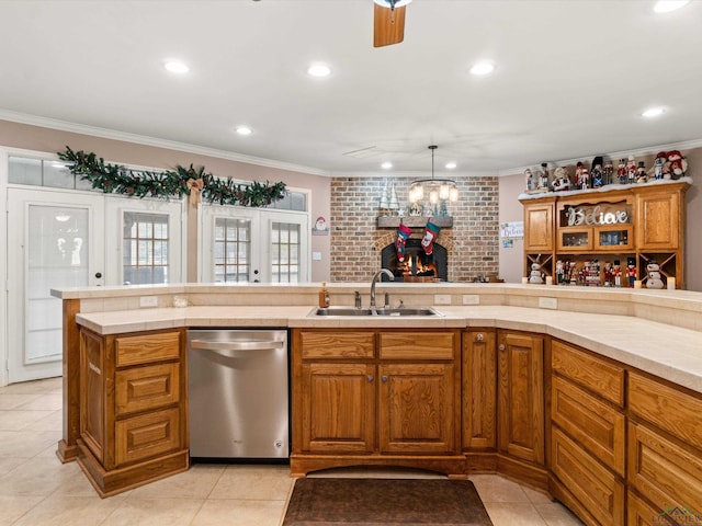 kitchen featuring sink, ornamental molding, stainless steel dishwasher, and hanging light fixtures