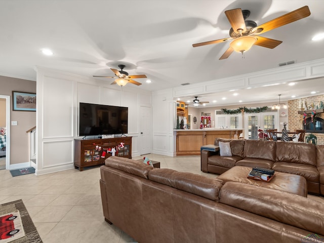 tiled living room with crown molding, brick wall, and an inviting chandelier