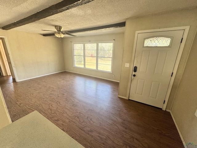 entryway featuring beamed ceiling, dark hardwood / wood-style floors, and a textured ceiling