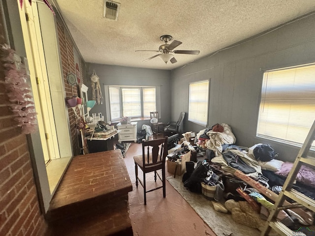 miscellaneous room with a textured ceiling and ceiling fan