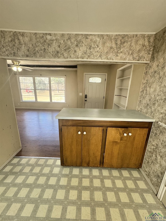 kitchen featuring ceiling fan and kitchen peninsula