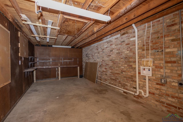 basement featuring brick wall