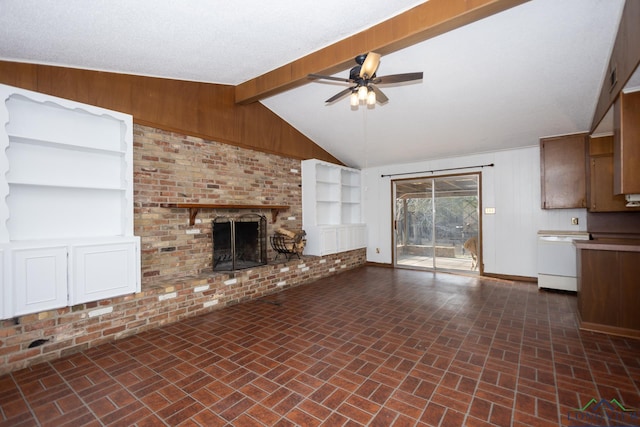 unfurnished living room featuring ceiling fan, wooden walls, a brick fireplace, and vaulted ceiling with beams