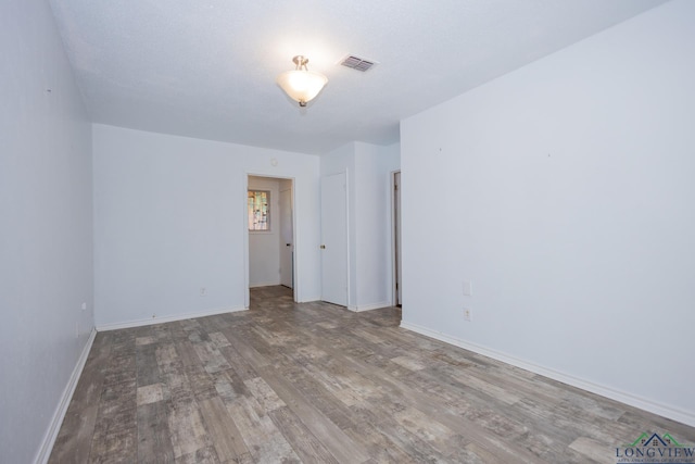 empty room with wood-type flooring