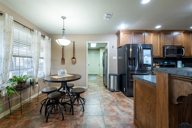 kitchen with tile patterned floors, backsplash, hanging light fixtures, stainless steel fridge, and fridge with ice dispenser