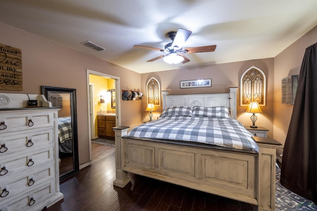 bedroom featuring ceiling fan, dark hardwood / wood-style flooring, and ensuite bath