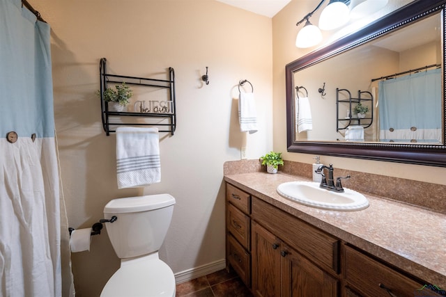 bathroom featuring toilet, tile patterned flooring, and vanity