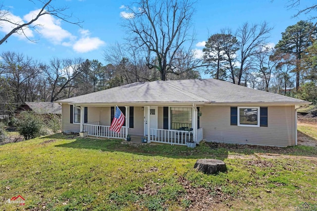 ranch-style house featuring a front yard and covered porch