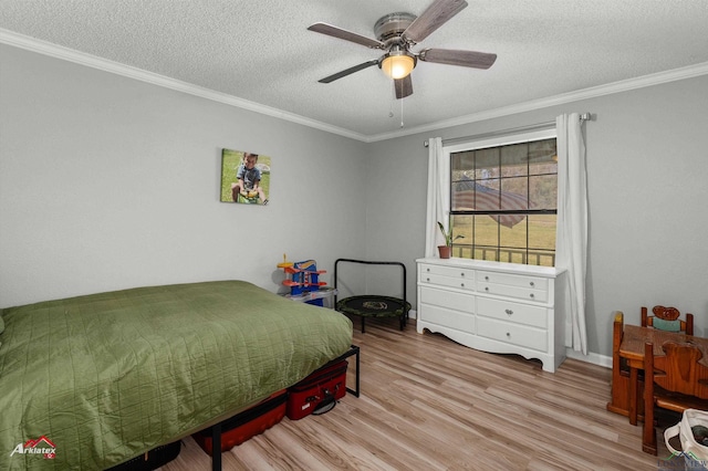 bedroom featuring a textured ceiling, ceiling fan, wood finished floors, and crown molding