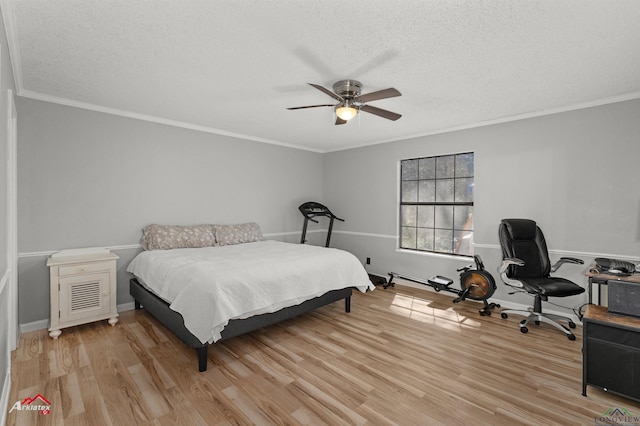 bedroom with a textured ceiling, ceiling fan, light wood-style flooring, baseboards, and crown molding