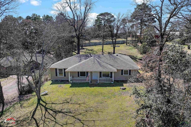 ranch-style house featuring a porch and a front lawn