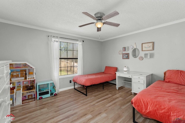 bedroom featuring light wood-type flooring, ornamental molding, and a textured ceiling