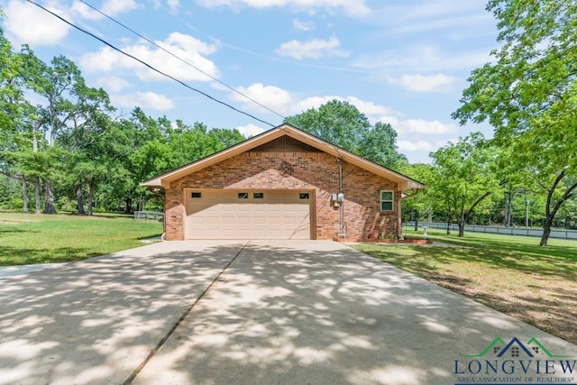 view of front of property with fence, brick siding, a garage, a front yard, and driveway