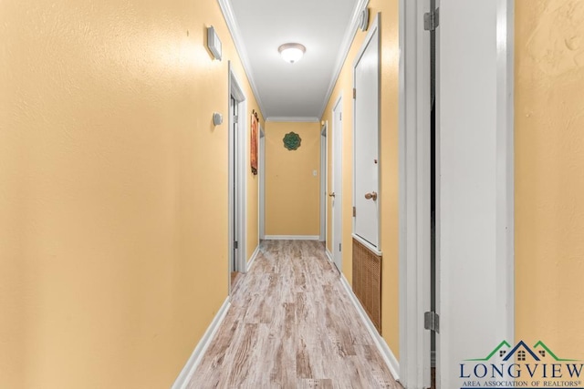 hall featuring baseboards and light wood finished floors