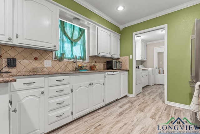 kitchen with independent washer and dryer, crown molding, white cabinetry, dishwasher, and light wood-style flooring