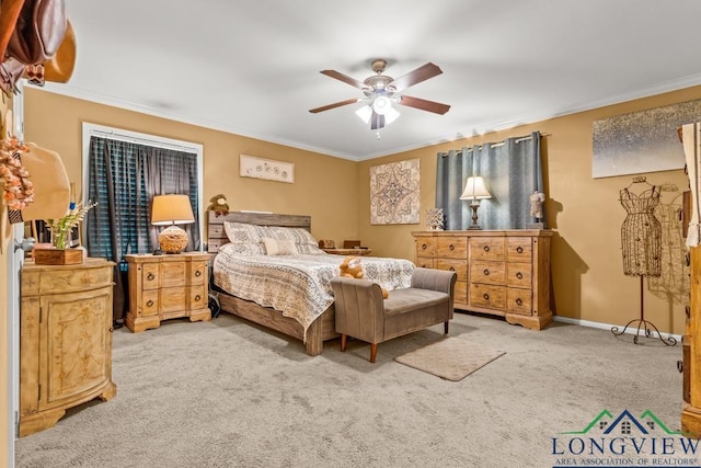 carpeted bedroom with baseboards, ornamental molding, and a ceiling fan