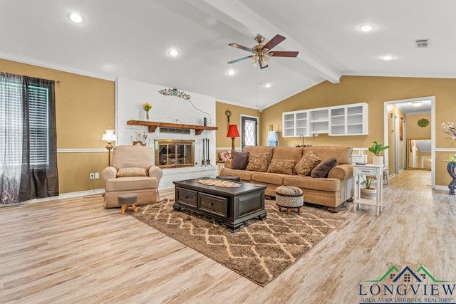 living room with visible vents, ceiling fan, wood finished floors, and vaulted ceiling with beams