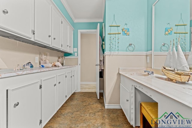 washroom with crown molding, baseboards, stone finish flooring, and a sink