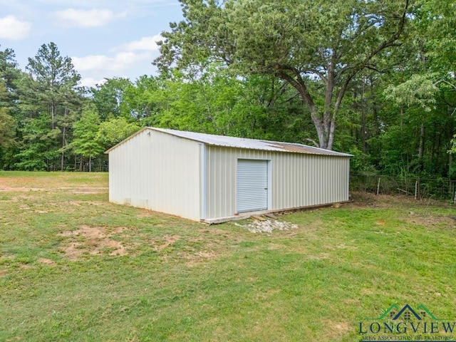 view of outbuilding featuring fence and an outbuilding