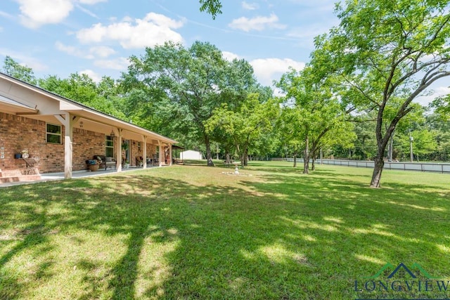 view of yard featuring a patio and fence