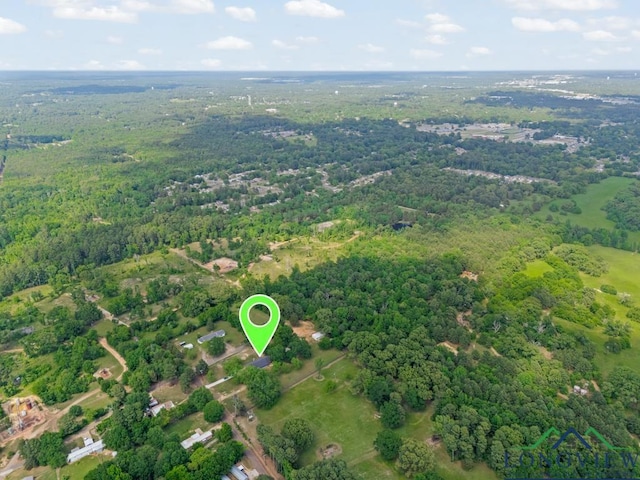 birds eye view of property with a wooded view