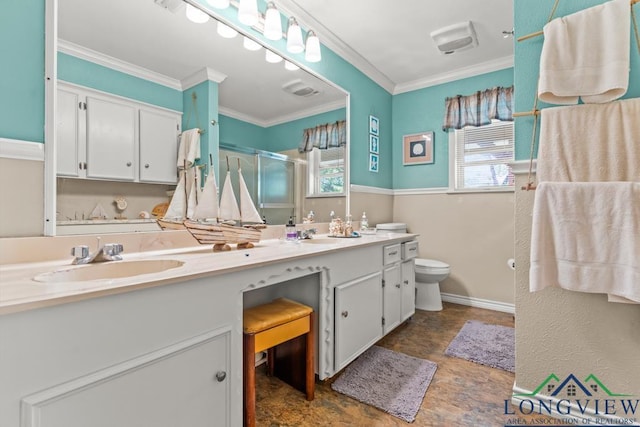 bathroom with crown molding, double vanity, toilet, a sink, and a stall shower