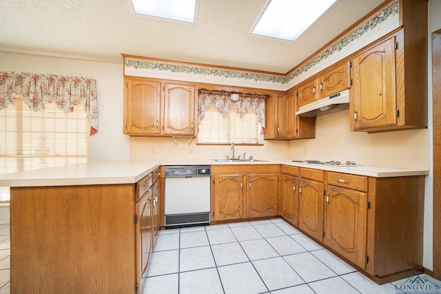 kitchen with sink, kitchen peninsula, a textured ceiling, white appliances, and light tile patterned floors