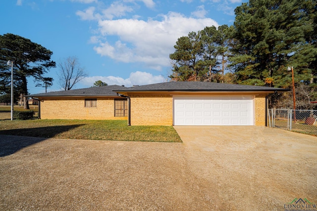 ranch-style home with a front yard and a garage