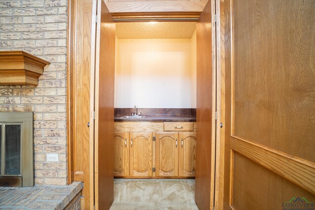 interior space featuring sink and light carpet