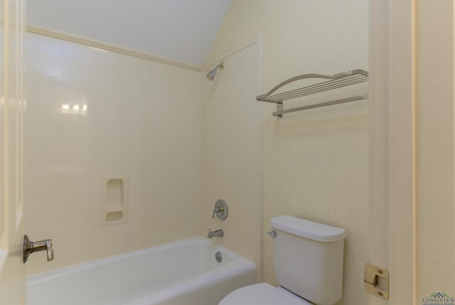 bathroom with toilet, shower / bath combination, and vaulted ceiling